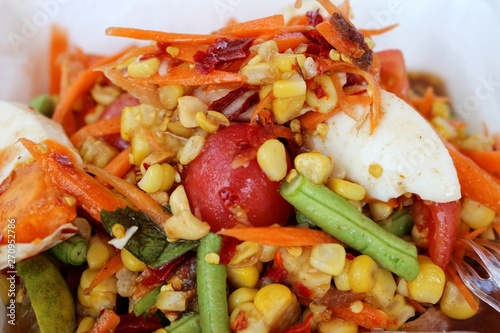  Spicy vegetable salad mixed with salted eggs and corn, papaya salad, fruit