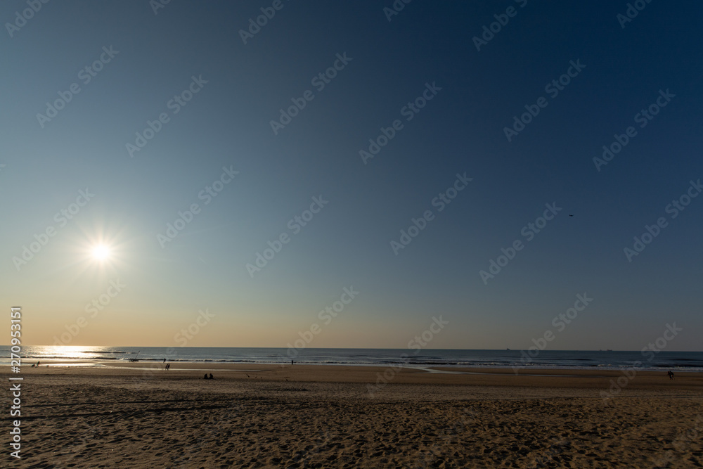 Sunny day on North sea beach in Netherlands in Schegeningen, tourist and vacation destination in Europe Sunny day on North sea beach in Netherlands in Schegeningen, tourist and vacation destination in Europe