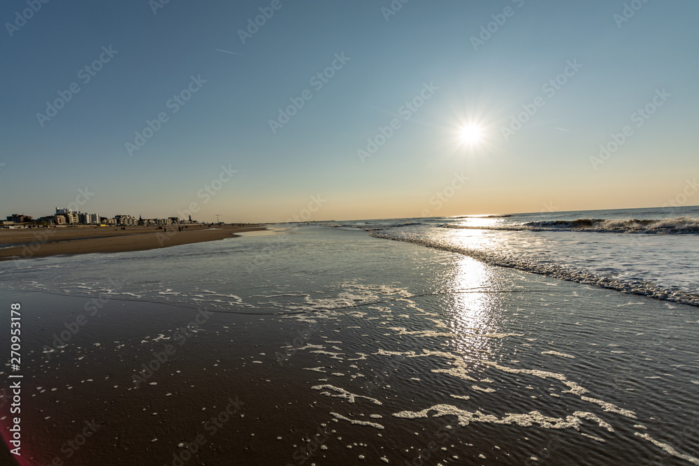 Sunny day on North sea beach in Netherlands in Schegeningen, tourist and vacation destination in Europe