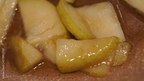 cooking caramelized pear on frying pan