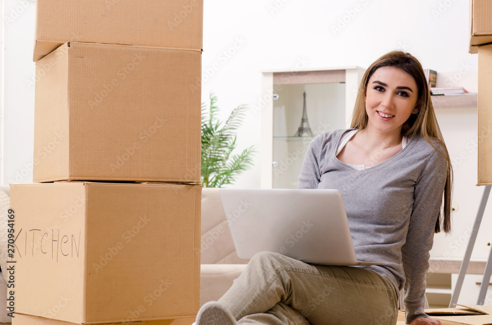 Young beautiful woman moving to new flat Young beautiful woman moving to new flat