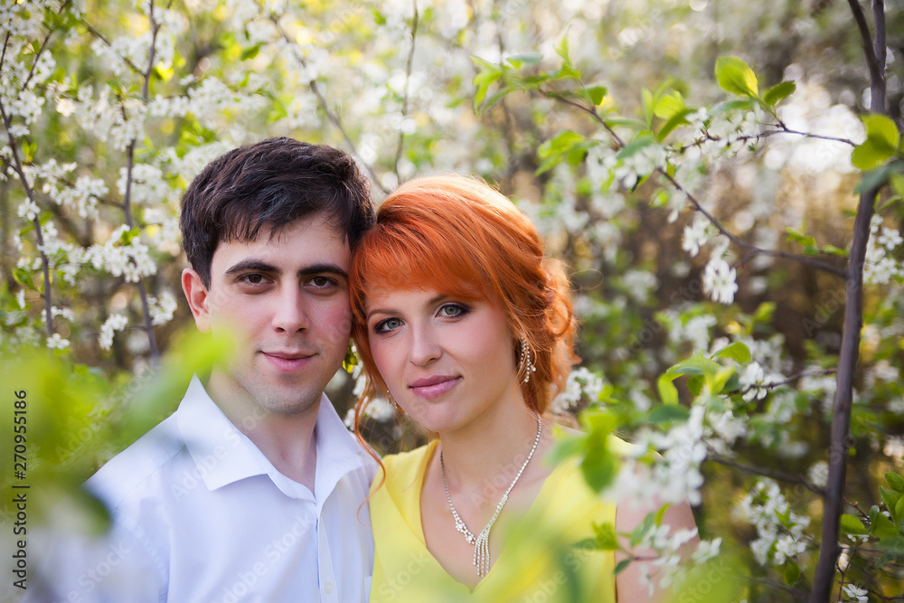 Romantic couple on background of flowering trees Romantic couple on background of flowering trees