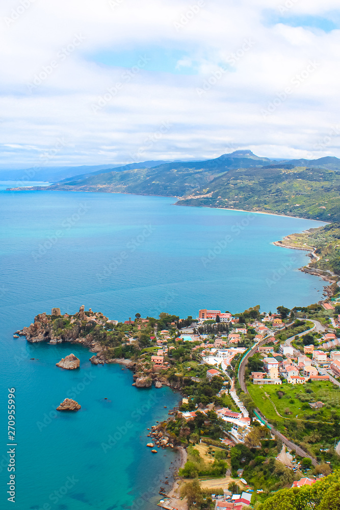Amazing view of a bay surrounding the coastal Sicilian village Cefalu from above with the hilly landscape in the background. The beautiful city is a popular Italian holiday destination