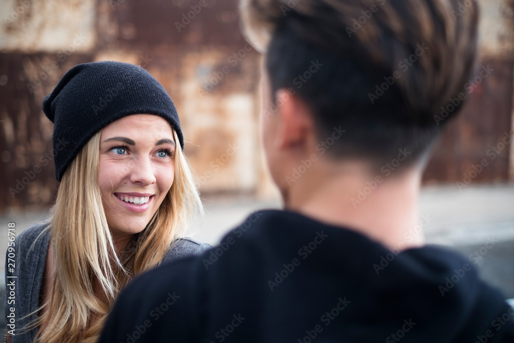 couple of teenagers enjoying and have fun together - relationship concept - guy looking at woman and woman looking at man smiling couple of teenagers enjoying and have fun together - relationship concept - guy looking at woman and woman looking at man smiling