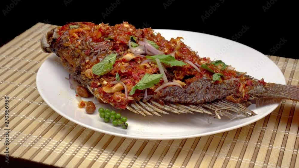 Slider short of fried fish with chili sauce in a plate