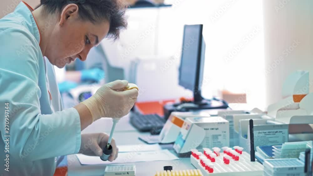Scientist pipetting liquids for research. Modern laboratory scientist conducts experiments in test tube