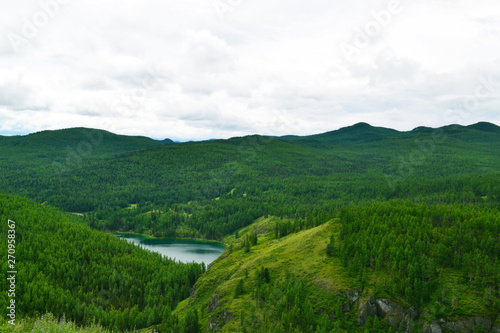 Top view on green hills and the lake. © Dasha Nefedova