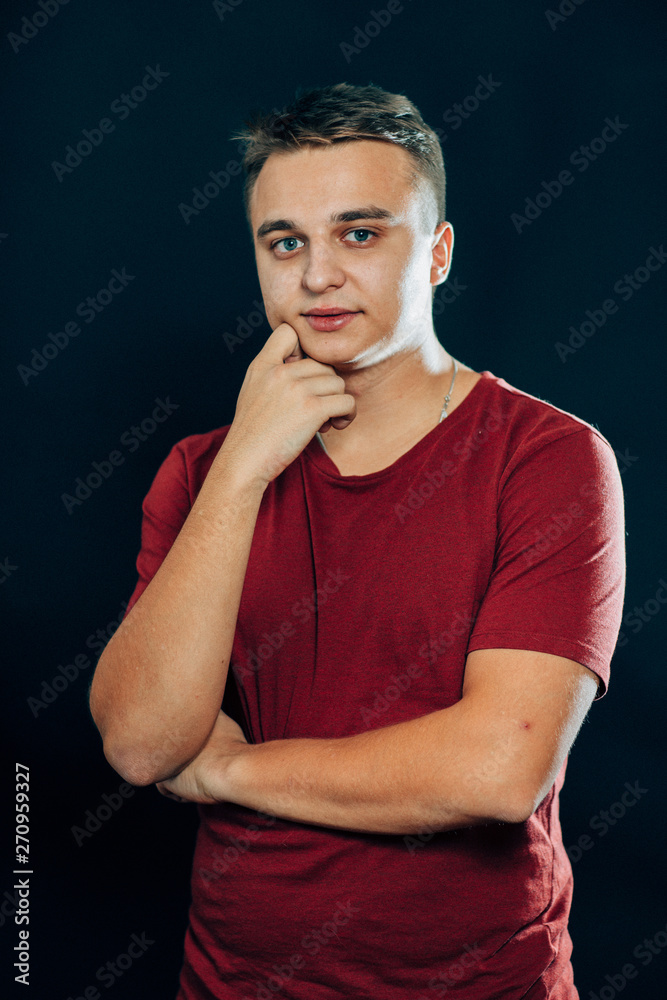 portrait of a young man on a dark background portrait of a young man on a dark background