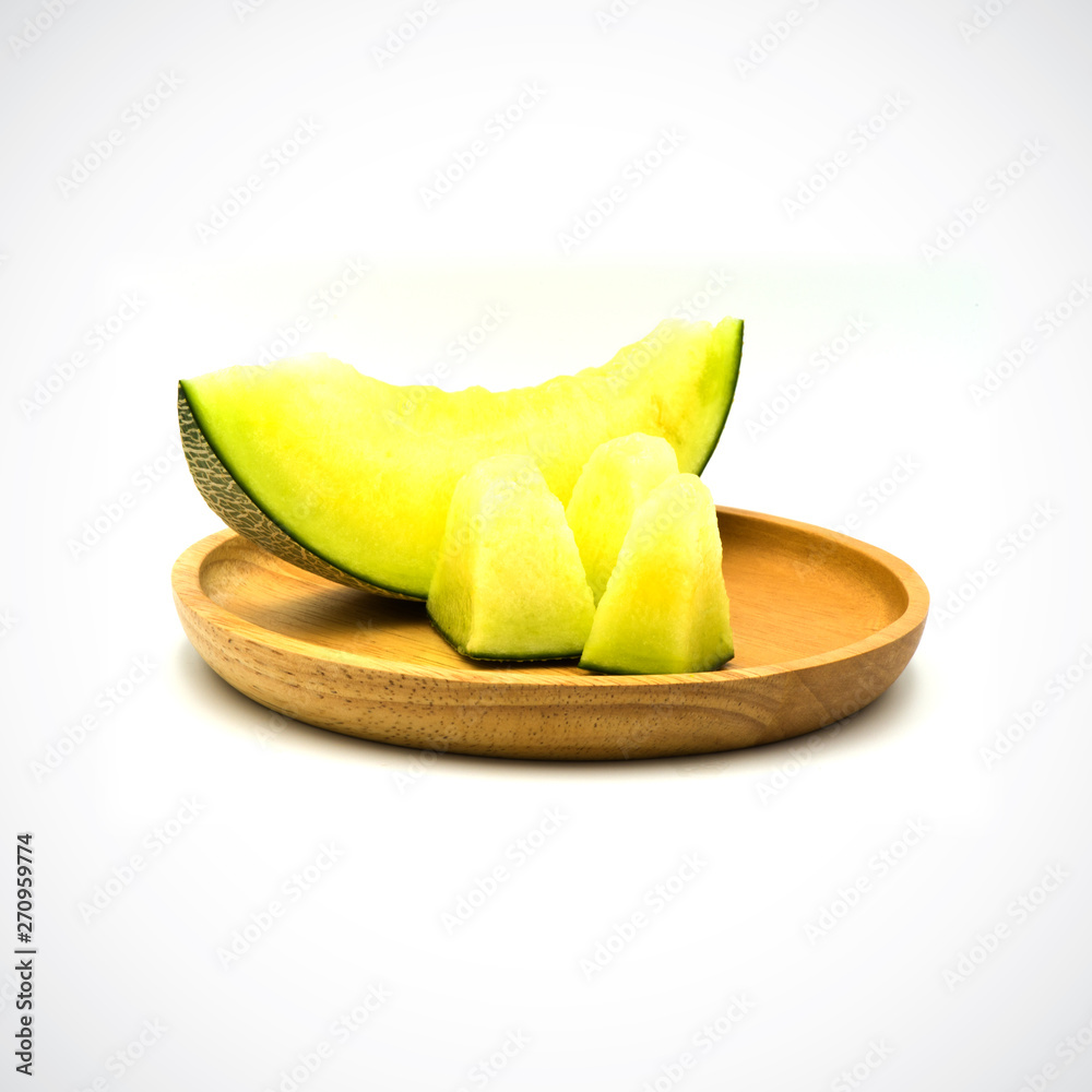 Cantaloupe Melon, In a wooden plate with green flesh on the White Blackground.