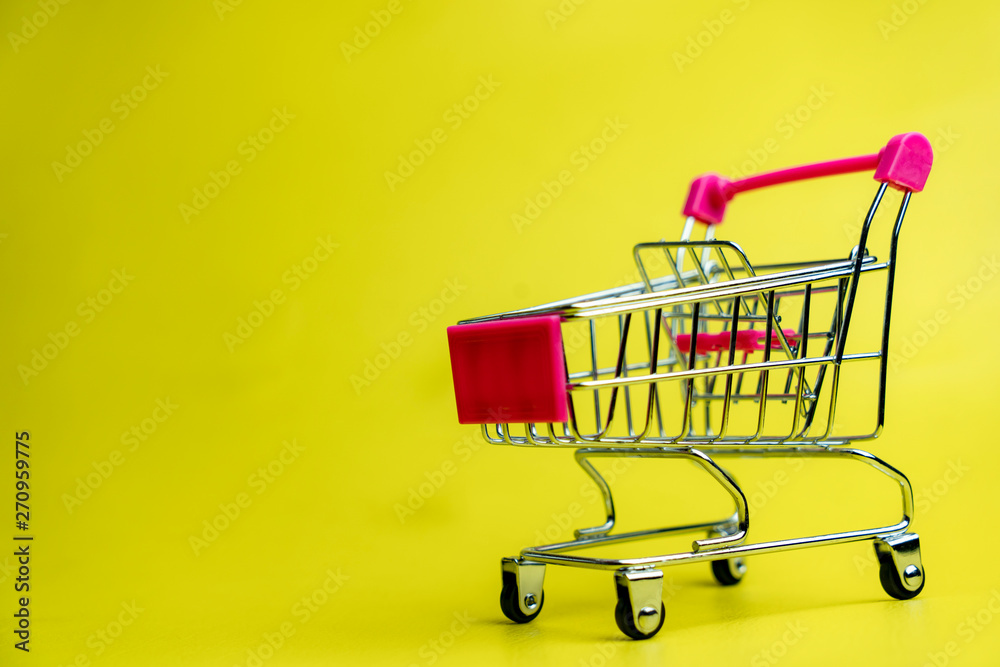 tiny shopping cart isolate on yellow background composition space 