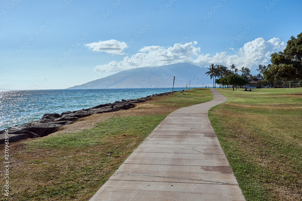 A view of a seaside sidewalk at a park in Maui.