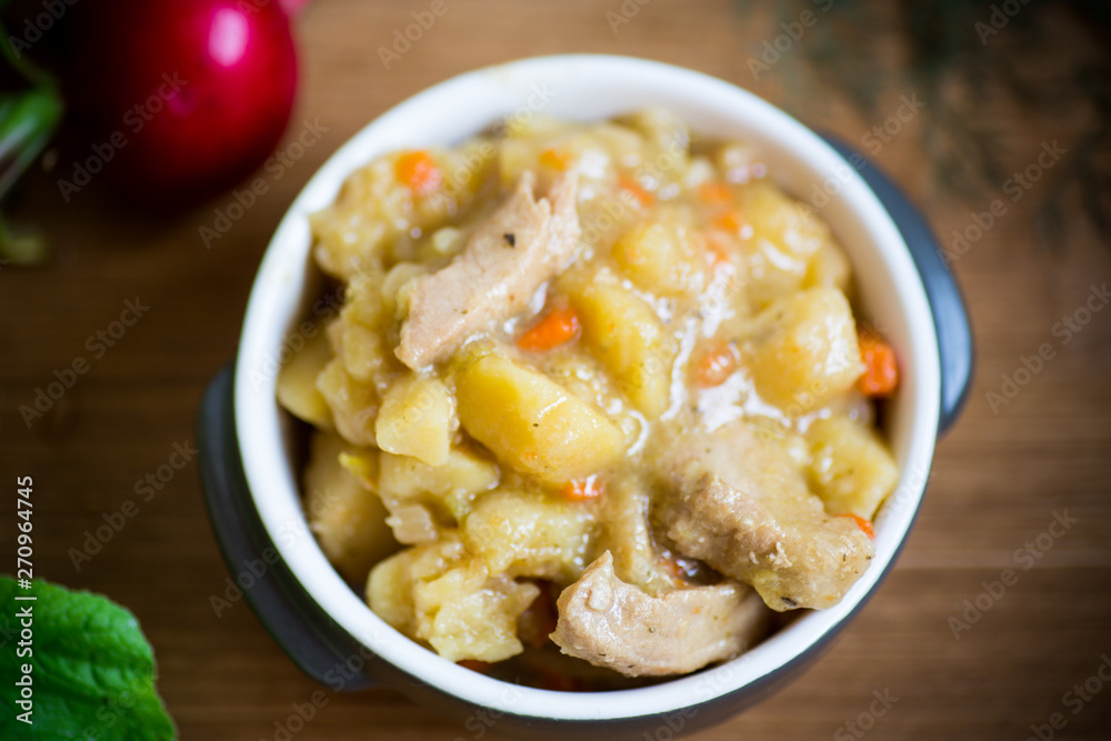 stewed potatoes with vegetables, cabbage and meat in a bowl