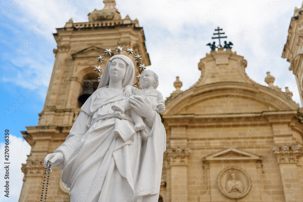 Statue of the Virgin Mary with child Jesus outside the Parish Church in Xaghra, Gozo, Malta.