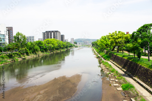 The image of River Shirakawa in Kumamoto, Japan. This shot was taken from bridge near Suidocho, which is central area in Kumamoto city.
