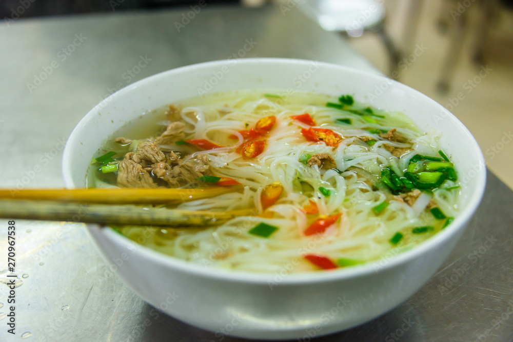A bowl of chicken noodle soup for breakfast in a restaurant in Hanoi, Vietnam A bowl of chicken noodle soup for breakfast in a restaurant in Hanoi, Vietnam