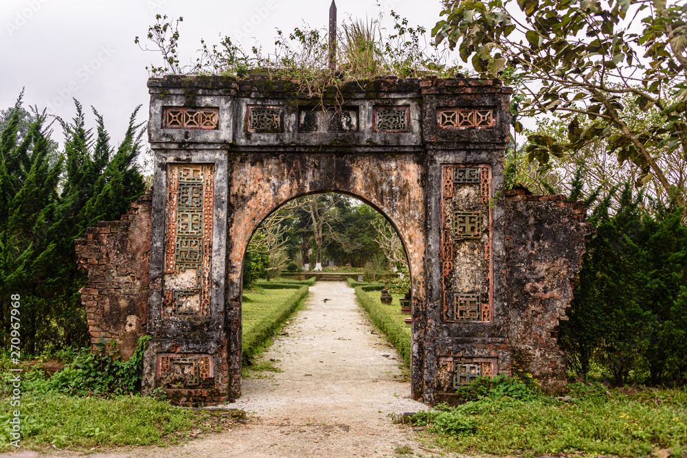 One of the many old archways in the gardens of Hoàng thành (Imperial City) a walled citadel built in 1804 in Hue, Vietnam.
