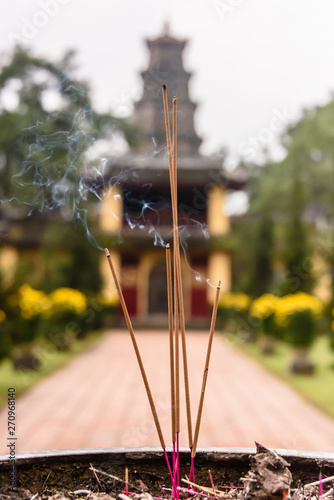 Incense burns in an urn to honour ancesters at Chùa Thiên Mụ (Pagoda of the Celestial Lady, also called Linh Mụ Pagoda) , Huế, Vietnam.