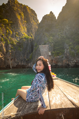 Young asian woman relax on long tail boat at Maya bay © witthaya