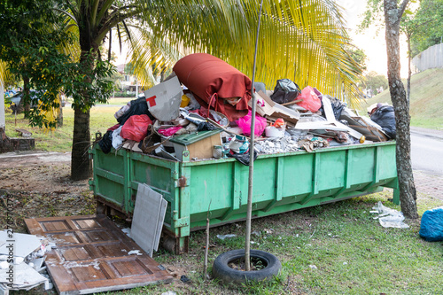 Removal rubbish dumpster bin with load of material for disposal photo