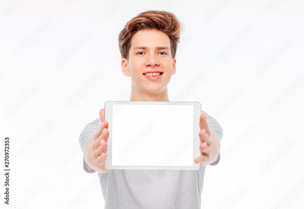 Attractive young man student teenager holding tablet with white screen, isolated on white background, mockup Attractive young man student teenager holding tablet with white screen, isolated on white background, mockup