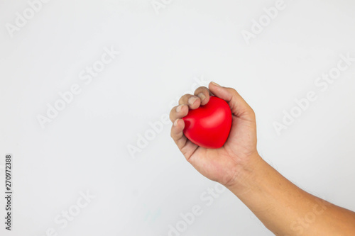 Young woman doctor holding a red heart