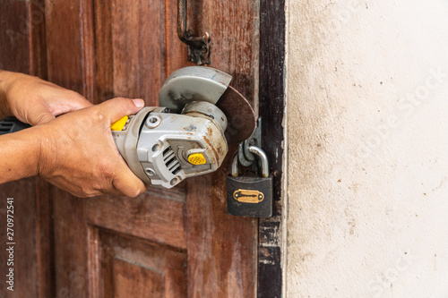 Worker was cutting lock on the door. photo