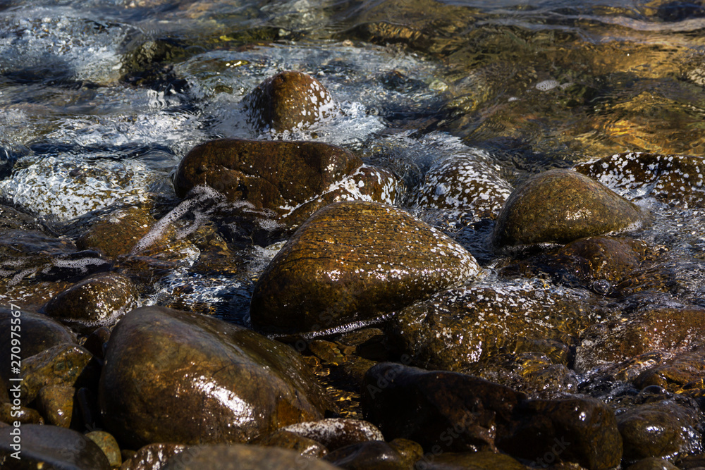 Smooth stones in the wave of the Sea, background Smooth stones in the wave of the Sea, background