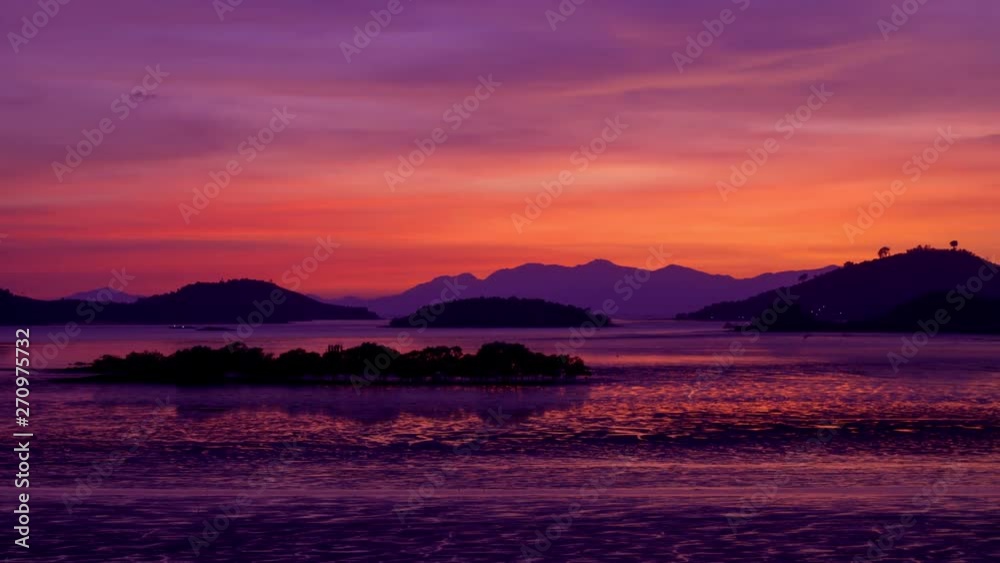 Sun Setting Behind Mountains around with water and tree landscape, Time-lapse , panning right. Sun Setting Behind Mountains around with water and tree landscape, Time-lapse , panning right.