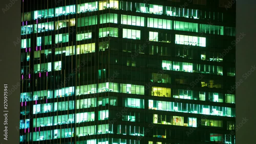 People working in modern office building in urban city, dusk to night time-lapse, tilt up. People working in modern office building in urban city, dusk to night time-lapse, tilt up.