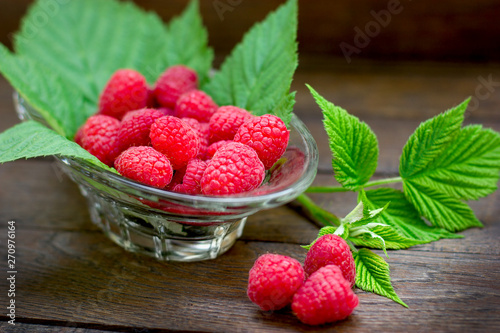 Delicious raspberry,  organic raspberries in glass bowl on table