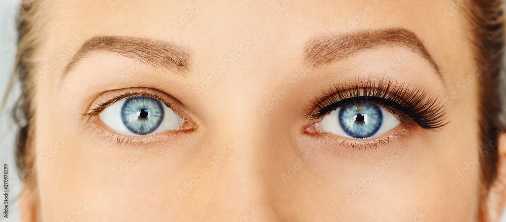 Naklejka premium Female eyes with long false eyelashes, befor and after change. Eyelash extensions, make-up, cosmetics, beauty