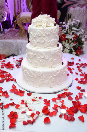 White wedding cake with beautiful colored roses