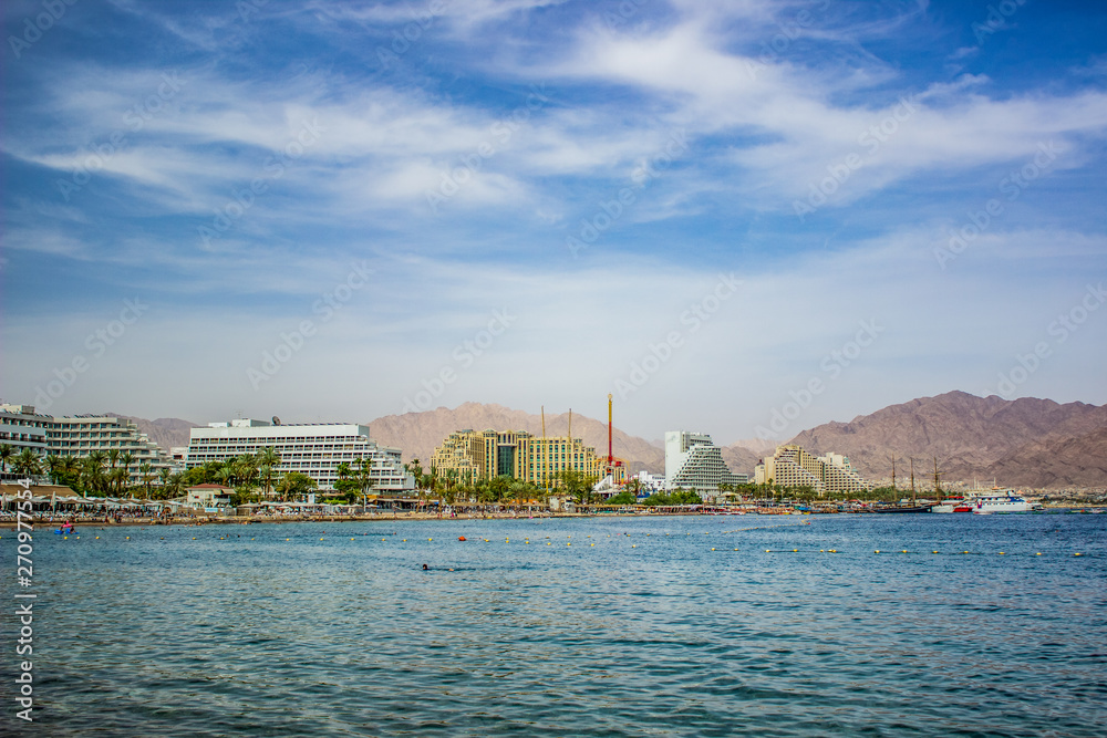 waterfront panorama of Israeli city Eilat harbor picturesque and bright touristic destination for summer vacation in Middle East district on a Red sea 