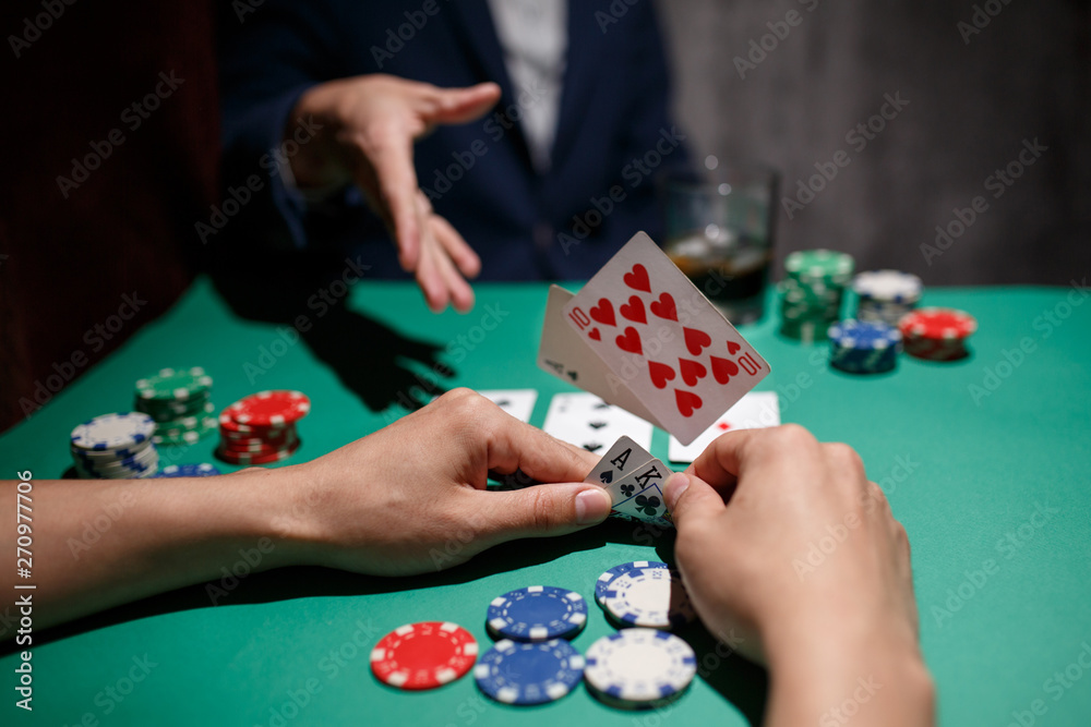professional poker game. Green poker table with two games. poker player folds by throwing cards on the table professional poker game. Green poker table with two games. poker player folds by throwing cards on the table