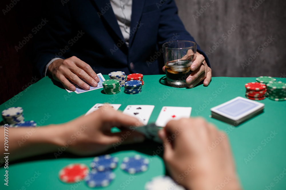 Poker Aces pair .green poker table with top pair. casino gambling. playing cards close-up. poker player watching his hand Poker Aces pair .green poker table with top pair. casino gambling. playing cards close-up. poker player watching his hand