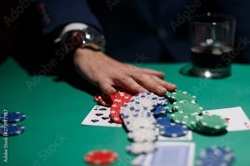 poker player bets all chips. Big poker risks. poker table and hands close-up