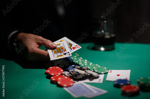 professional poker game. Green poker table with two games. poker player folds by throwing cards on the table