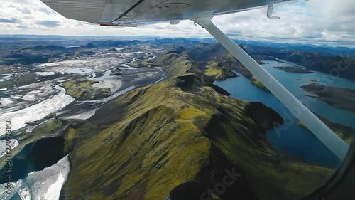 flying on small plane above volcanic landscape in Iceland, view from the window