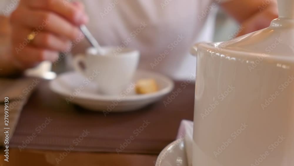 Man holding a cup of tea in hands and drinking. A cup of tea on a table. Close up shot. Man holding a cup of tea in hands and drinking. A cup of tea on a table. Close up shot.