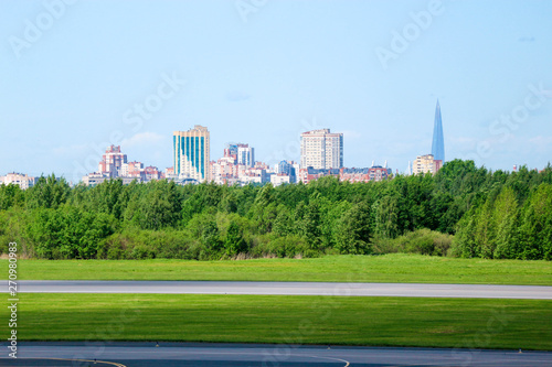 view of Saint Petersburg city silhouette from Pulkovo airport with runway and forest on the foreground photo