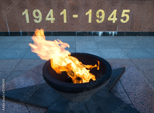 Burning eternal flame with dates of memory photo