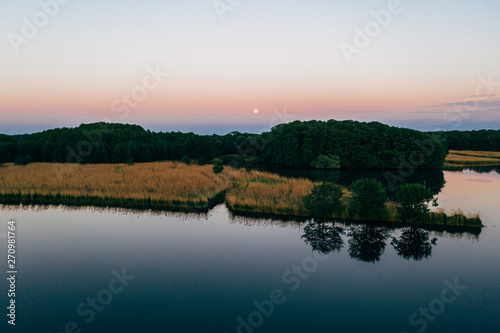 Aerial shot of the fishing ponds after sunset, southern Poland. 