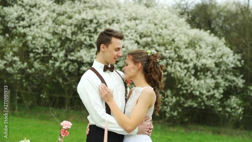 Kissing bride and groom during wedding in nature more detailed view of newlyweds in nature.