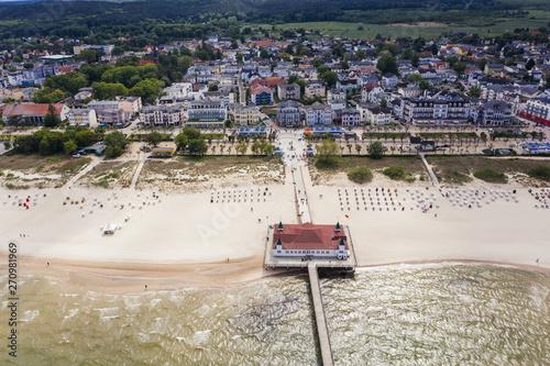 Baltic sea beach with beach baskets and the pier.  photo