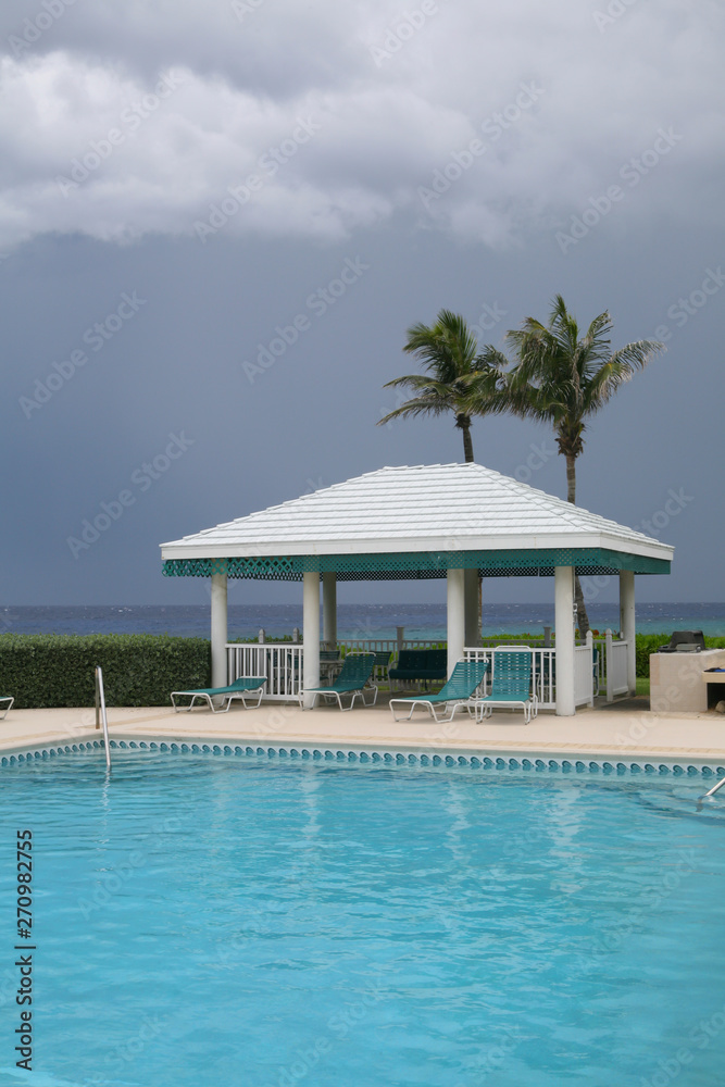 empty swimming pool with a stormy sky in the background