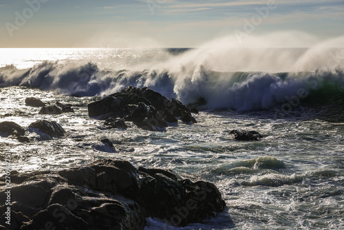 Rocks of Atlantic Ocean seen from beach in Porto, Portugal photo