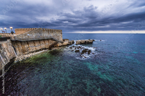 Ionian Sea and Old Town walls on Ortygia isle, Syracuse city, Sicily Island in Italy