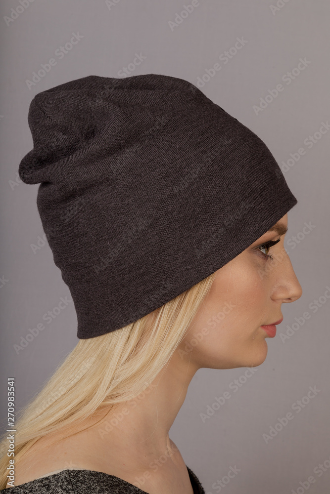 Beautiful girl with natural make-up in a headdress on a gray background. Beautiful girl with natural make-up in a headdress on a gray background.