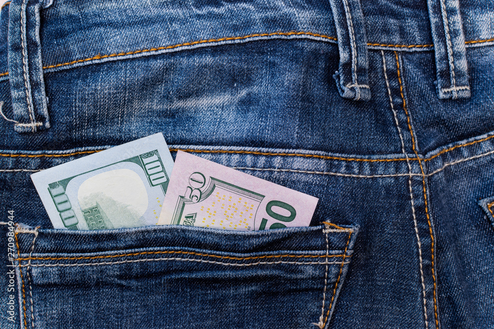 Banknotes of 50 and 100 dollars in the back pocket of jeans. Cash money Banknotes of 50 and 100 dollars in the back pocket of jeans. Cash money