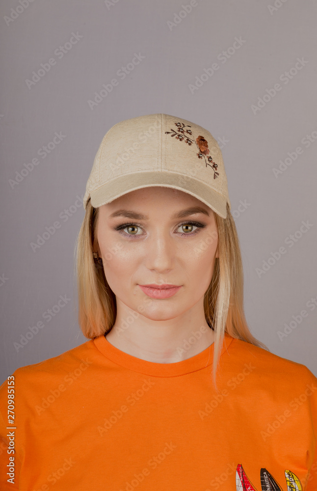 Beautiful girl with natural make-up in a headdress on a gray background. Beautiful girl with natural make-up in a headdress on a gray background.